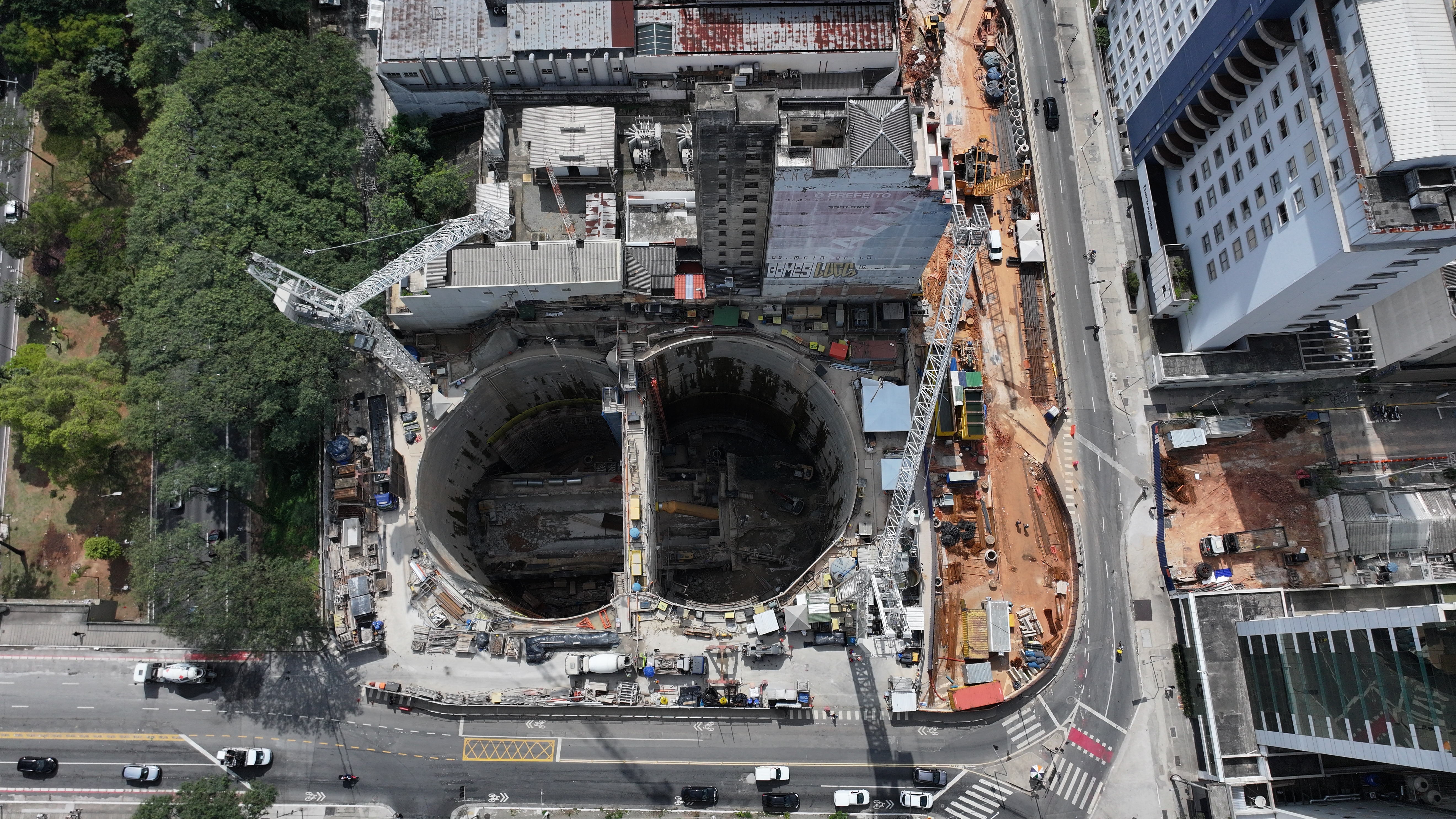 建設中のサンジョアキン駅の上空写真。巨大な空洞の右側を走る道路がリベルダーデ大通り、右上がサンジョアキン街の角にある病院で、その手前がピラピチニングイ街となり、写真のすぐ右外に山口県人会館(Divulgação Linha Una 4月撮影)